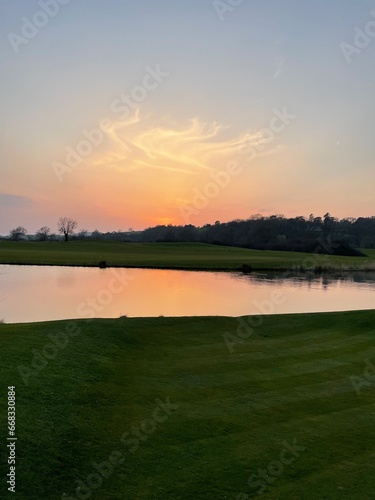 Sunset on the 2010 ryder cup gold course reflecting onto the calm and clear lake