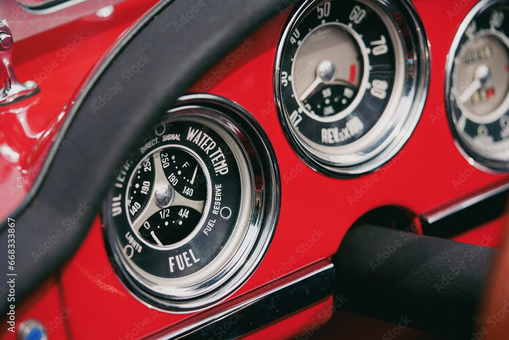Vintage dashboard with various gauges on a retro car