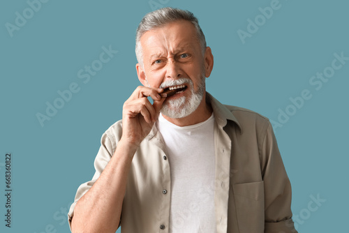 Mature man eating tasty cho...