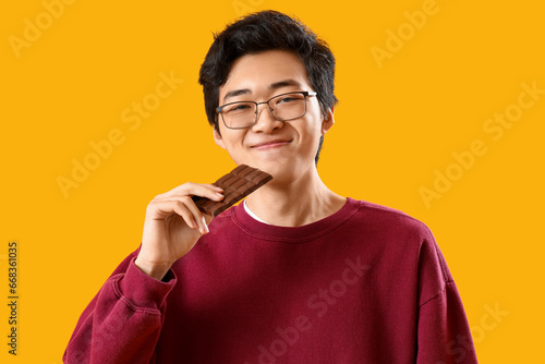 Young Asian man eating tast...