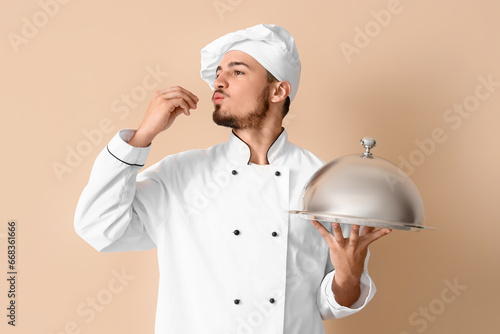 Male chef with cloche on be...