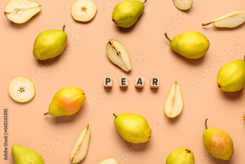 Word PEAR and fresh fruits on orange background