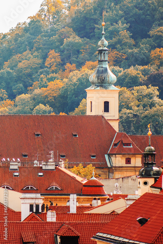 Beautiful view of an old building with a spire. Multicolored colors of autumn and old Prague, vertical photo