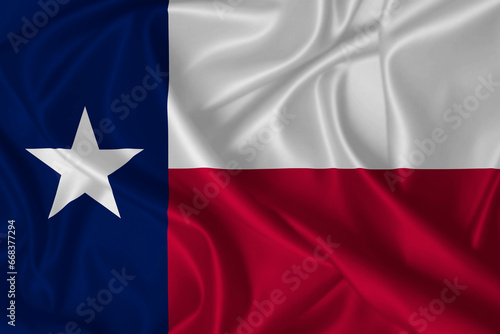 Flag of Texas blowing in the wind on fabric texture