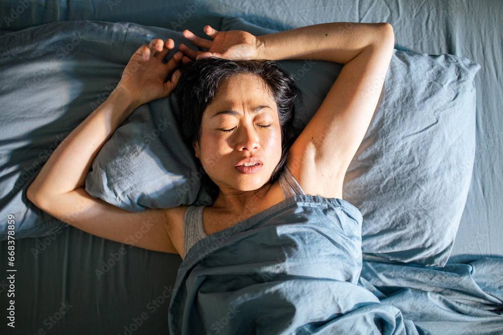 Young Asian woman sleeping in her bed at home Stock Photo | Adobe Stock