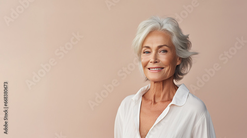 An Elderly Mature Woman wearing white is isolated against a pastel background with copy space, beautiful and confident