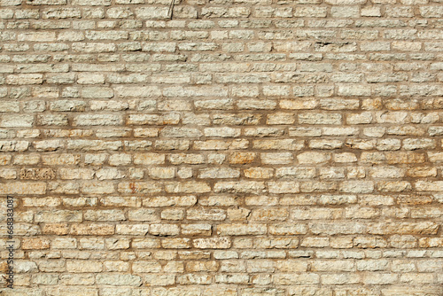 An ancient wall made of gray old bricks in Tallinn. Texture
