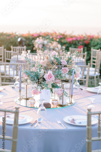 elegantly decorated table at a wedding reception with beautiful sunset