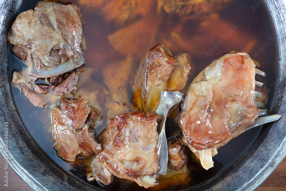 Turkish cuisine lamb for roasting. Roasted lamb chops. Close-up of lamb ribs cooked in oil in a pot. Turkish cuisine lamb for roasting. Roasted lamb chops. Close-up of lamb ribs cooked in oil in a pot.