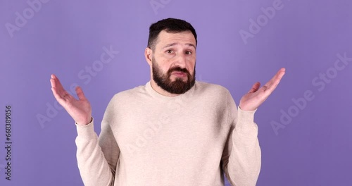 Young handsome bearded man making I don't know gesture on purple background.  photo