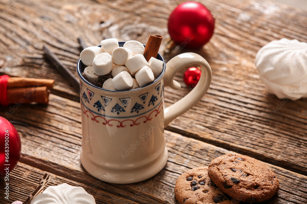 Cup of hot cocoa with marshmallows, cinnamon and sweet cookies on wooden background Cup of hot cocoa with marshmallows, cinnamon and sweet cookies on wooden background