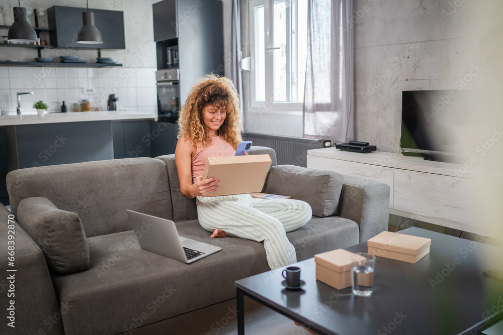 one woman checking box of received package or product at home one woman checking box of received package or product at home
