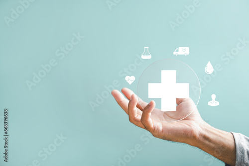 Fototapeta Naklejka Na Ścianę i Meble -  A hand holds a plus icon for medical care, indicating advantages. Health insurance health concept featuring access to welfare health and room for content.