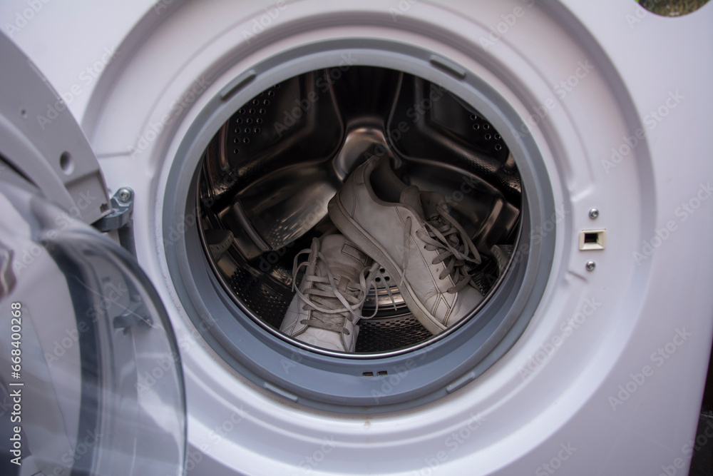 Dirty old sneakers waiting to be washed in the washing machine Dirty old sneakers waiting to be washed in the washing machine