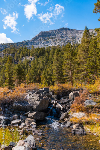 Fototapeta Naklejka Na Ścianę i Meble -  Hiking in Little Lakes Valley in the Eastern Sierra Nevada Mountains outside of Bishop, California. Alpine lakes, fall leaf colors, snow capped mountains and evergreen trees combine to make a pictures