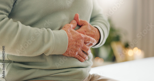 Hands, stomach pain with closeup and gut health, person has digestion issue and nutrition with elderly care. Sick, colon and gas with healthcare and wellness, help and support for stress and illness photo