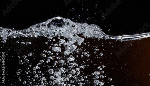 soda water bubbles splashing underwater against black background cola liquid texture that fizzing and floating up to surface like a explosion in under water for refreshing carbonate drink concept