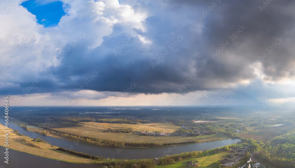 dramatic blue sky with dark gray clouds before rain wide aerial panorama