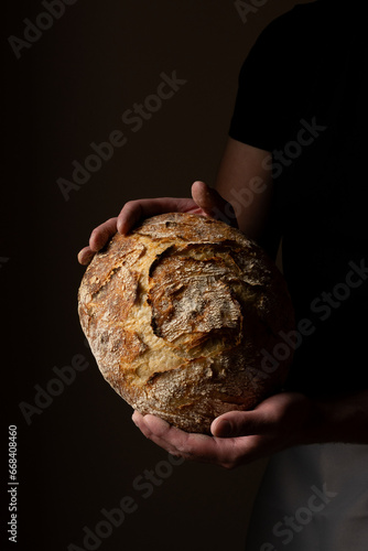 Принти на полотні Attractive young Caucasian chef posing with white sourdough bread
