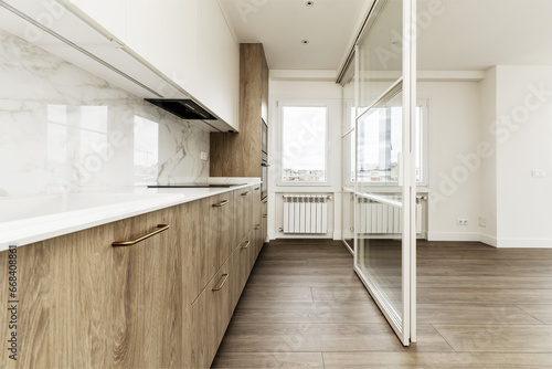 Modern open kitchen with white metal and glass retractable screen © Toyakisfoto.photos