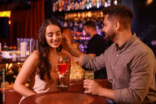Lovely couple with fresh cocktails in bar