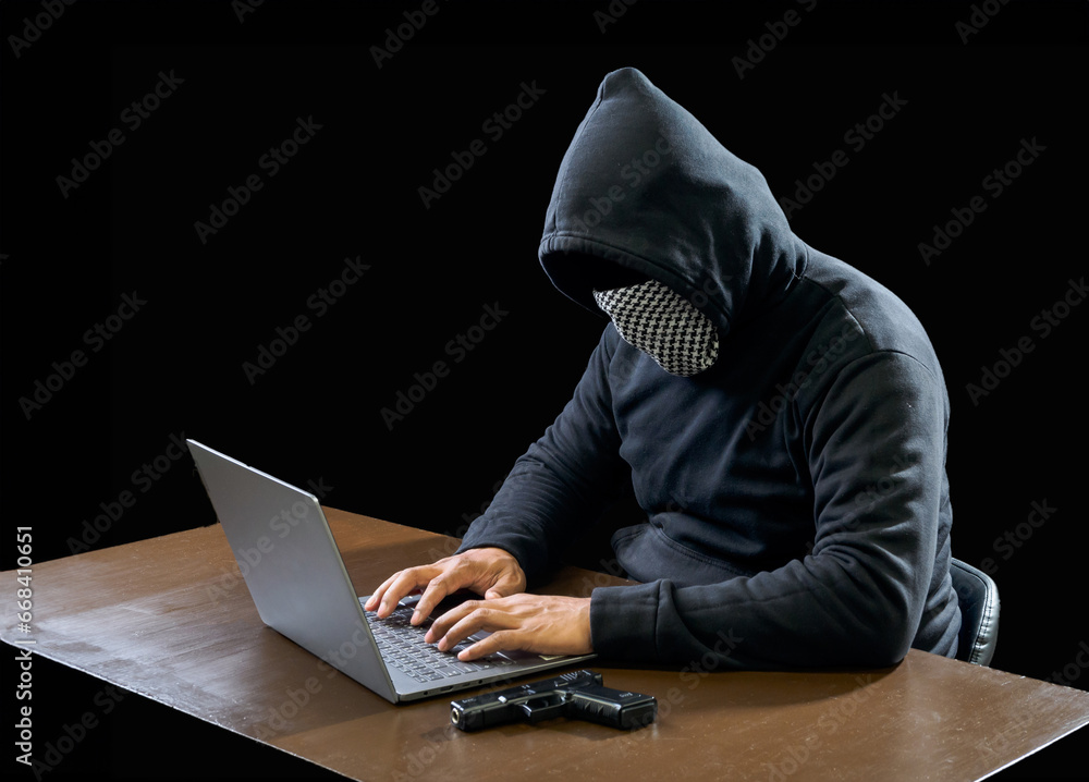 Hacker spy man one person in black hoodie sitting on a table looking computer laptop used login password attack security to circulate data digital in internet network system, night dark background. Hacker spy man one person in black hoodie sitting on a table looking computer laptop used login password attack security to circulate data digital in internet network system, night dark background.