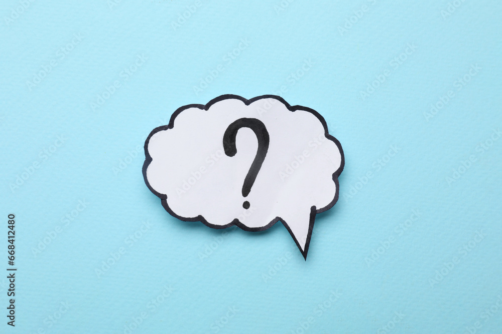 Paper speech bubble with question mark on light blue background, top view Paper speech bubble with question mark on light blue background, top view
