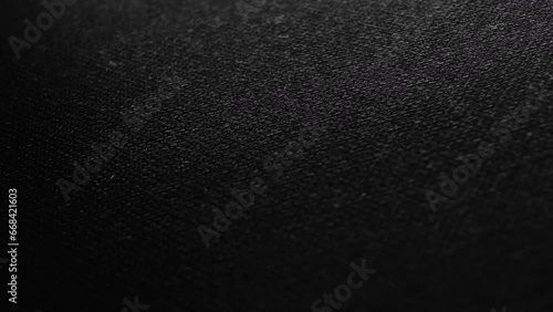Close-up dolly shot of DARK FABRIC with visible texture and soft curves. Neutral backdrop for titles, logos, or design overlays.
