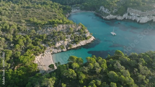 Aerial over a catamaran and the beautiful Macarelleta beach in Menorca photo