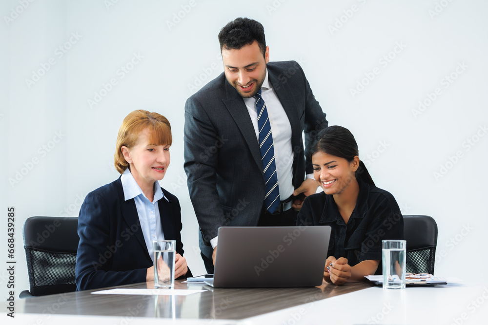Three smiling diverse business colleagues having business strategy meeting. Three smiling diverse business colleagues having business strategy meeting.