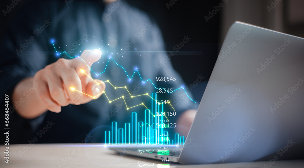 investment and finance concept, businessman touching virtual trading graph and blurred light on hand, stock market, profits and business growth. investment and finance concept, businessman touching virtual trading graph and blurred light on hand, stock market, profits and business growth.