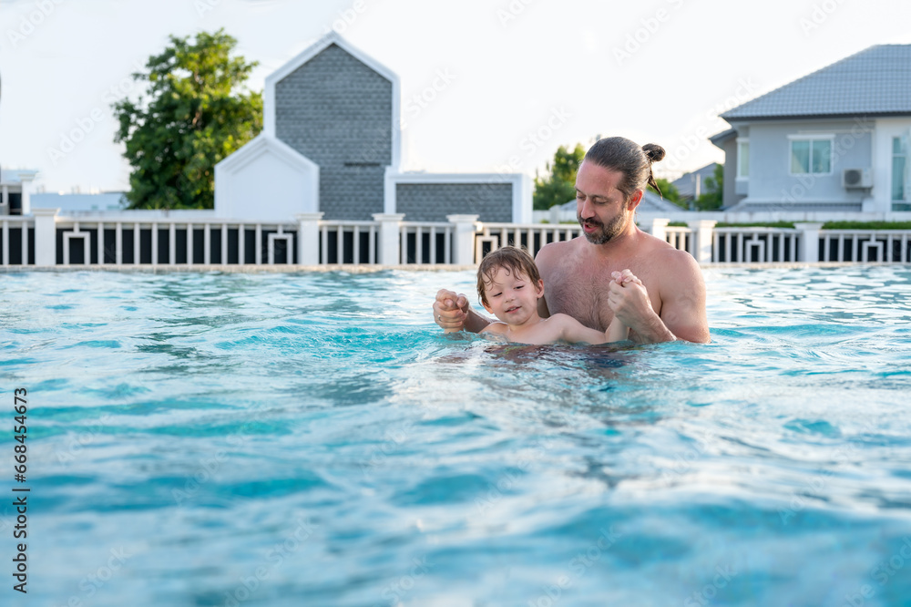 Happy family children in swimming pool .Funny kids playing outdoors. Summer vacation concept.
