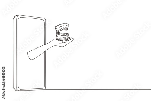Single continuous line drawing hand comes out from the smartphone holding dentures. Special application about oral health and its anatomy. Online consultation. One line design vector illustration