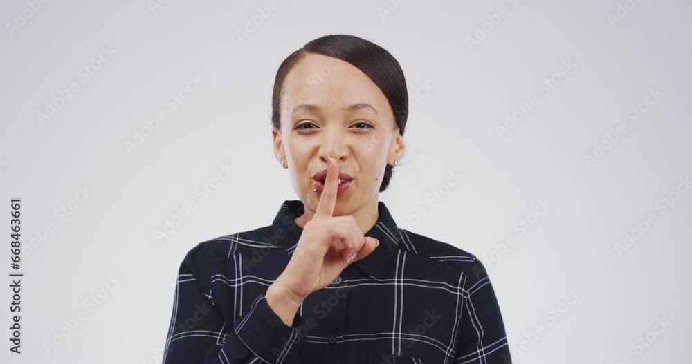 Face, secret and woman with gossip on a studio background with finger on lips. Smile, portrait and a girl or person with hand on mouth for a rumor, whisper or gesture for noise or silence on backdrop Face, secret and woman with gossip on a studio background with finger on lips. Smile, portrait and a girl or person with hand on mouth for a rumor, whisper or gesture for noise or silence on backdrop