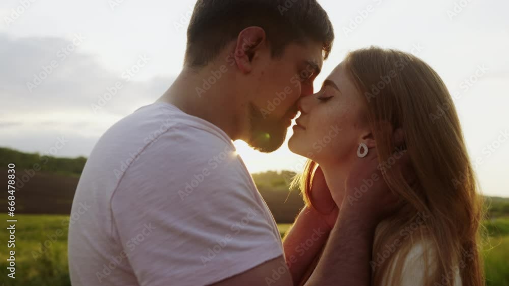 Couple lovers hugging and kissing in the park at sunset. Love, youth, happiness concept. Couple lovers hugging and kissing in the park at sunset. Love, youth, happiness concept.