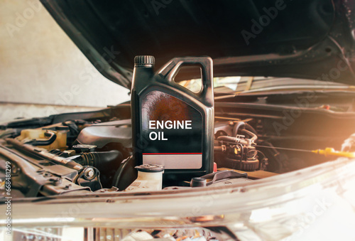 Car engine oil gallon or lubricate oil gallon on car engine compartment with sunlight Car miantenance concept photo