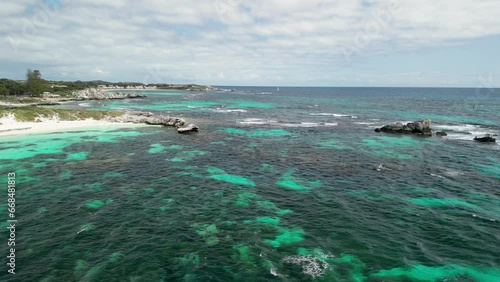 Aerial of Rottnest Island, sandy shores gently caressed by the crystal-clear waters of the Indian Ocean, Longreach Bay offers a haven of natural beauty and tranquility. Vacation and traveling concept. photo