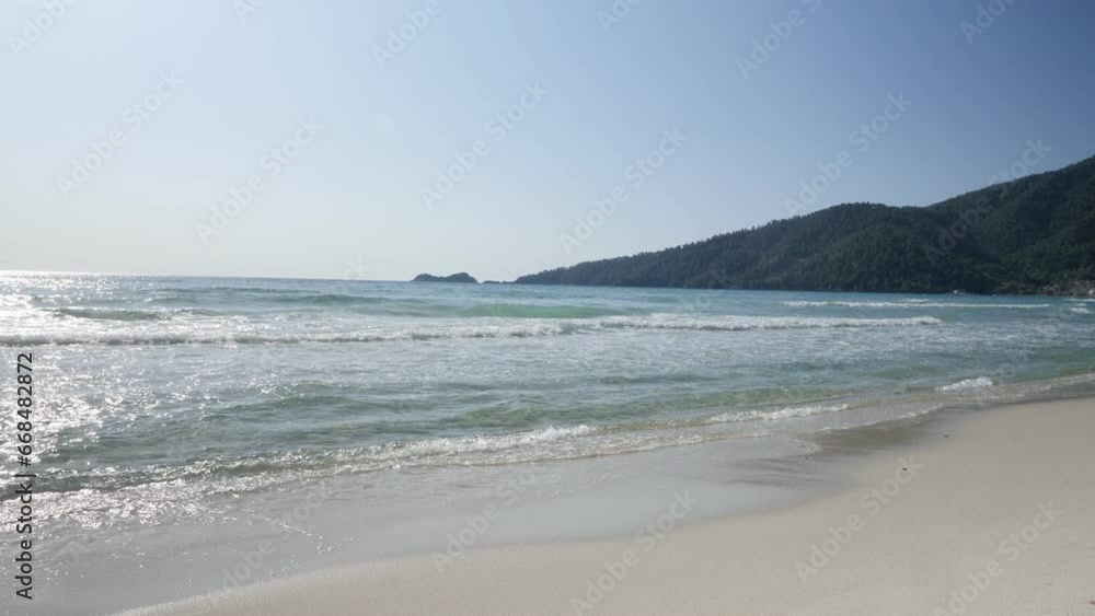 Wave crashing onto yellow sand beach on Thasos island, Greece. Wave crashing onto yellow sand beach on Thasos island, Greece.