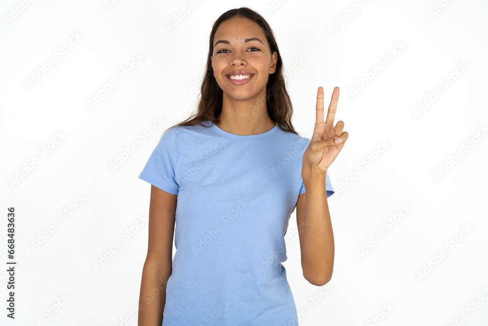 Beautiful girl wearing blue T-shirt showing and pointing up with fingers number two while smiling confident and happy. Beautiful girl wearing blue T-shirt showing and pointing up with fingers number two while smiling confident and happy.