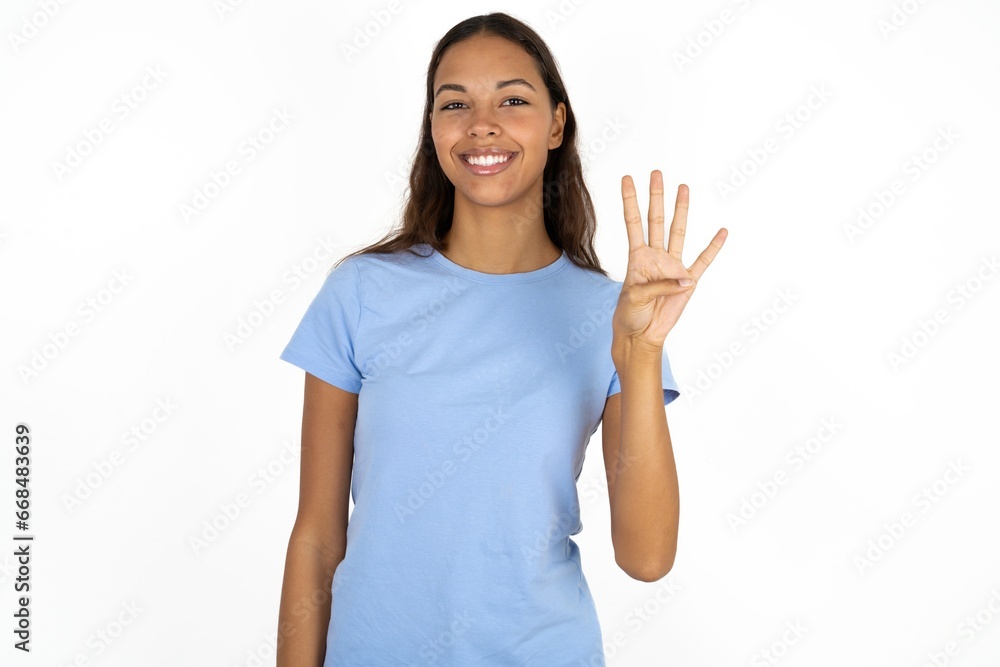 Beautiful girl wearing blue T-shirt showing and pointing up with fingers number four while smiling confident and happy. Beautiful girl wearing blue T-shirt showing and pointing up with fingers number four while smiling confident and happy.