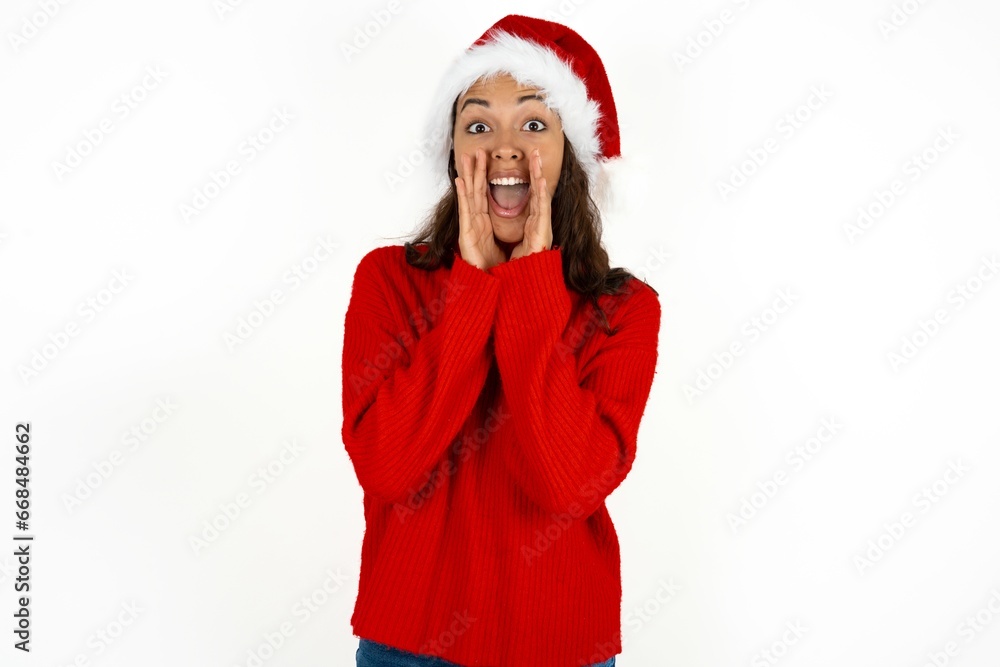 Beautiful girl wearing red sweater and Santa hat shouting excited to front. Beautiful girl wearing red sweater and Santa hat shouting excited to front.