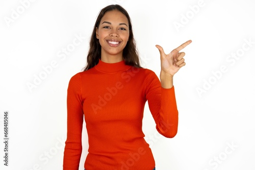 Beautiful girl wearing red sweater pointing up with fingers number eight in Chinese sign language BÄ. photo