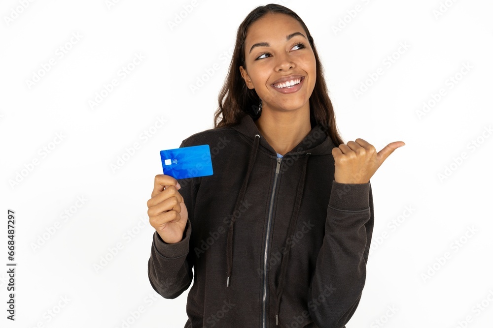 young beautiful woman hold credit card point empty space young beautiful woman hold credit card point empty space