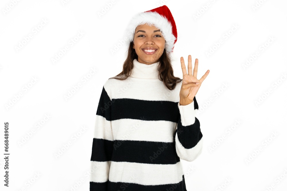 Beautiful woman wearing christmas hat showing and pointing up with fingers number four while smiling confident and happy. Beautiful woman wearing christmas hat showing and pointing up with fingers number four while smiling confident and happy.