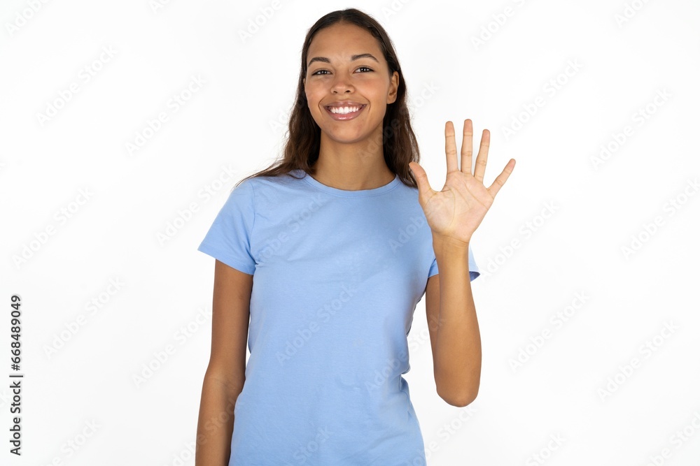 Young beautiful woman showing and pointing up with fingers number five while smiling confident and happy. Young beautiful woman showing and pointing up with fingers number five while smiling confident and happy.
