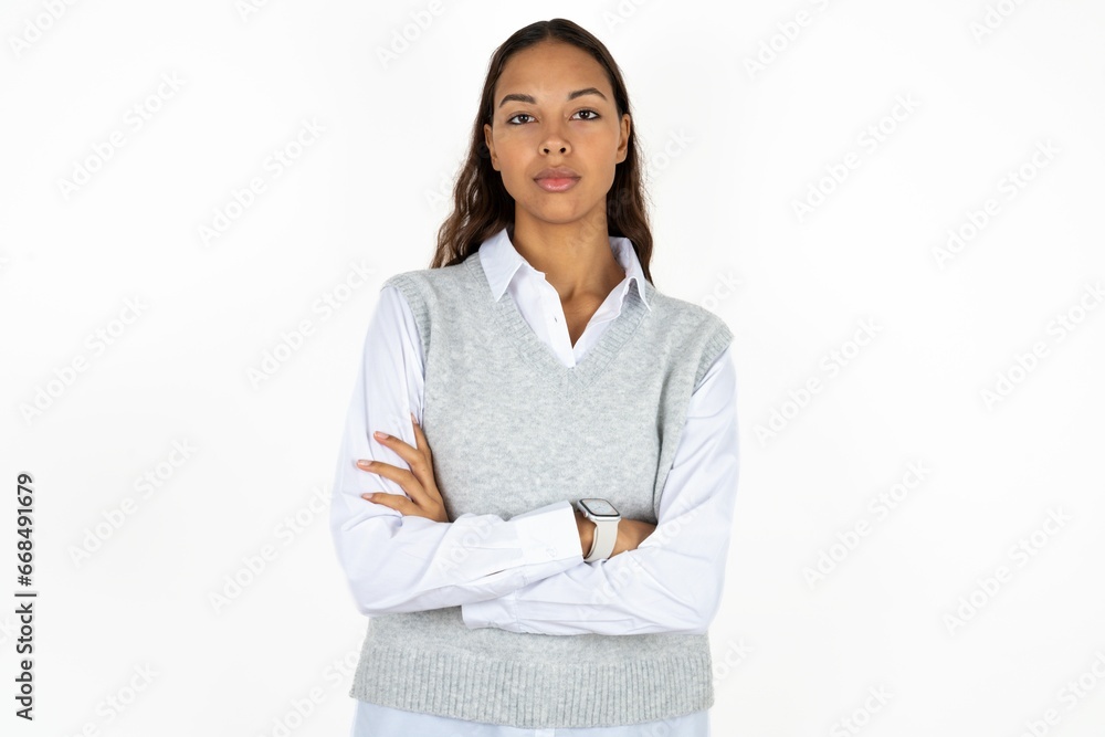 Self confident serious calm Young beautiful woman stands with arms folded. Shows professional vibe stands in assertive pose. Self confident serious calm Young beautiful woman stands with arms folded. Shows professional vibe stands in assertive pose.