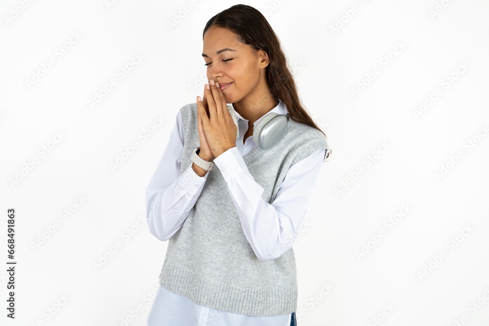 Overjoyed Young beautiful woman laughs joyfully and keeps palms pressed together hears something funny Overjoyed Young beautiful woman laughs joyfully and keeps palms pressed together hears something funny
