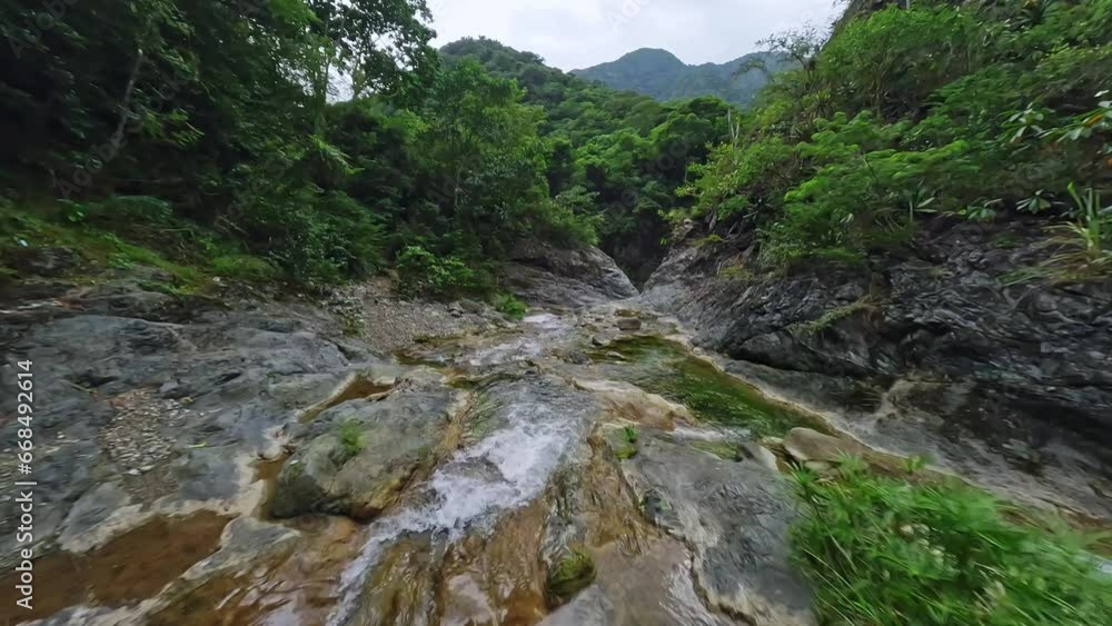 Fpv drone flight over rocky river bani surrounded by vegetated nature on Dominican Republic Fpv drone flight over rocky river bani surrounded by vegetated nature on Dominican Republic