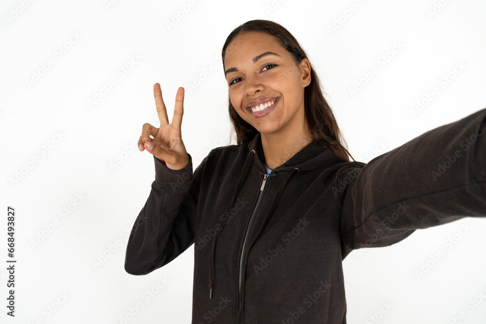 Positive Young beautiful woman take selfie make v-sign Positive Young beautiful woman take selfie make v-sign