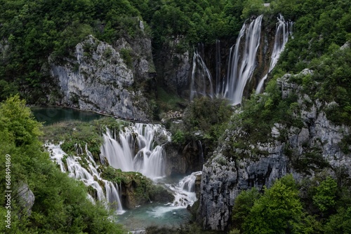 Tranquil scene of the Plitvice Lakes in Croatia with waterfalls surrounded by lush green foliage